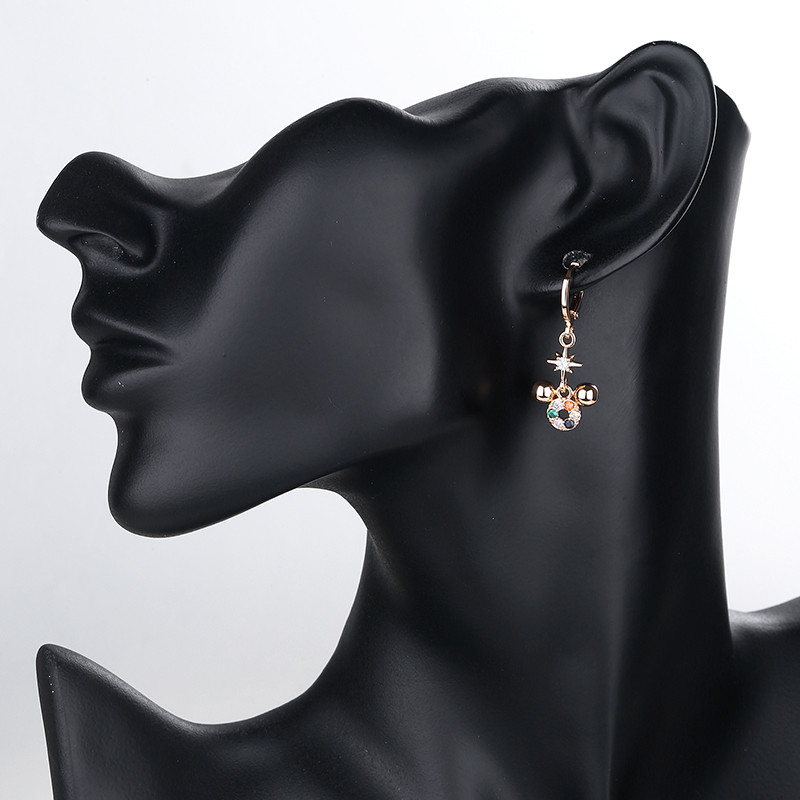 wearing black owl dangle huggie earring