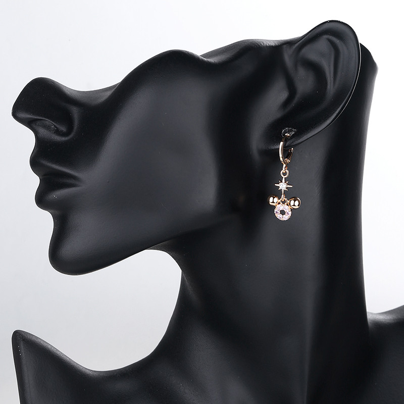 wearing black owl dangle huggie earring