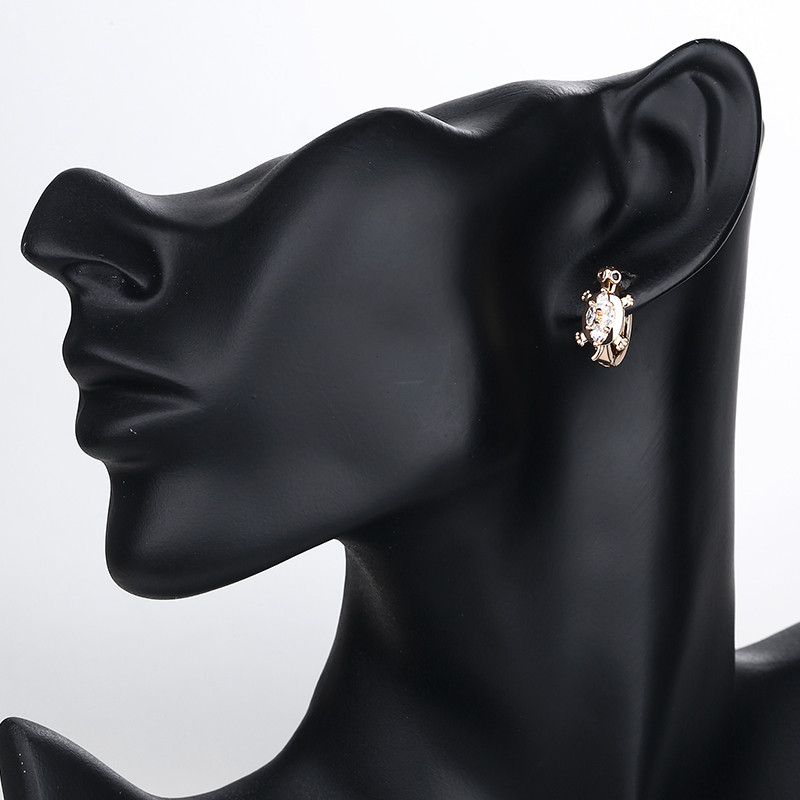 white turtle huggie earring wearing