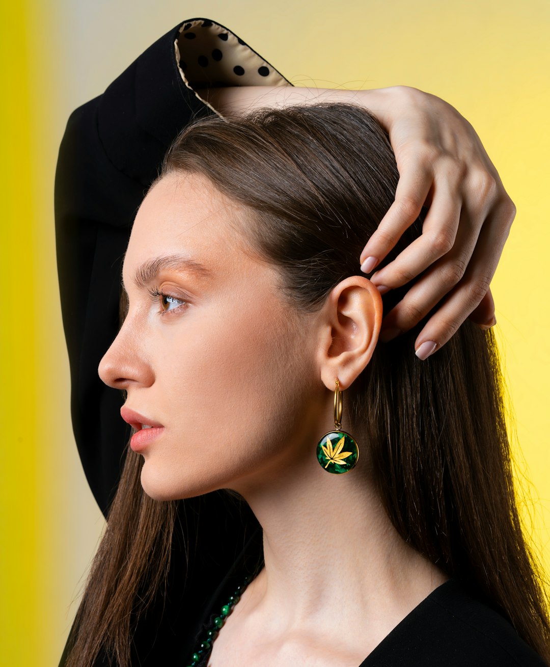 A model wearing minimalist gold huggie earrings