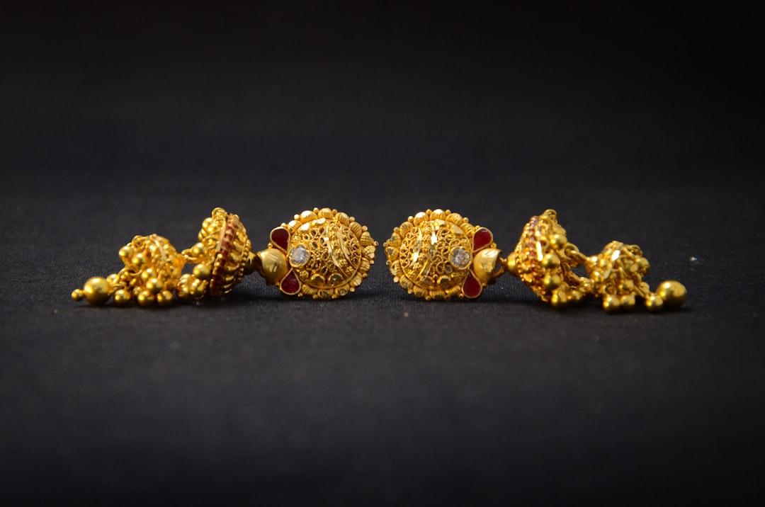 A collection of womens huggie earrings in gold and silver