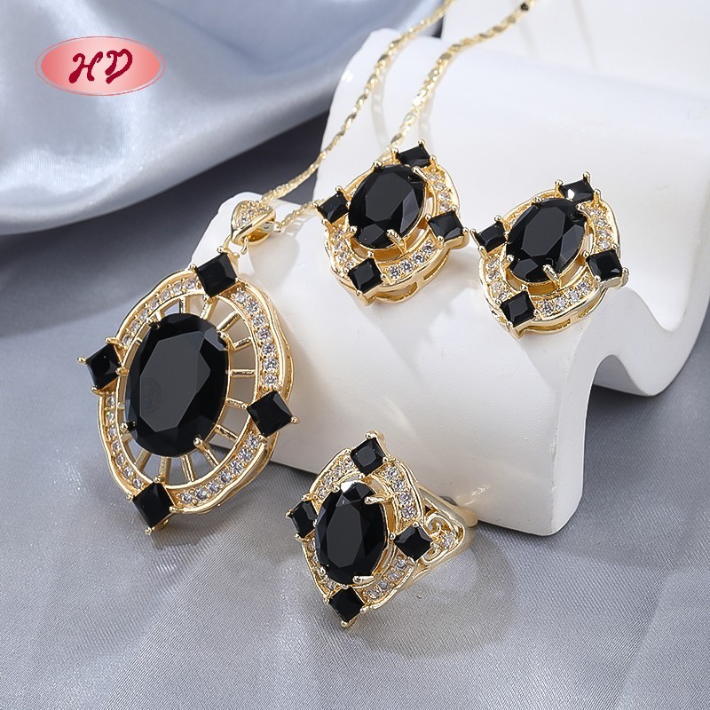 Conjunto de anillo, collar y aretes con gemas rojas en oro de 18 quilates