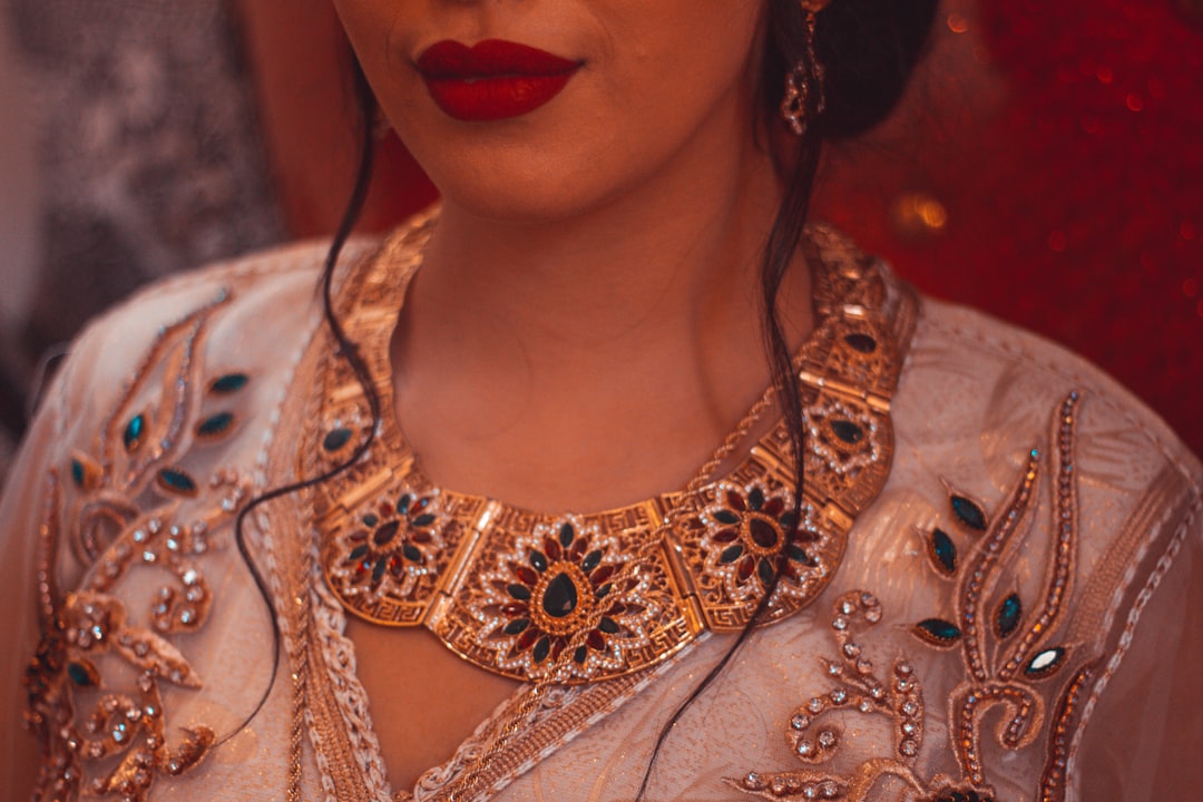 A model wearing a cohesive set of leopard-themed jewelry, including a necklace and earrings