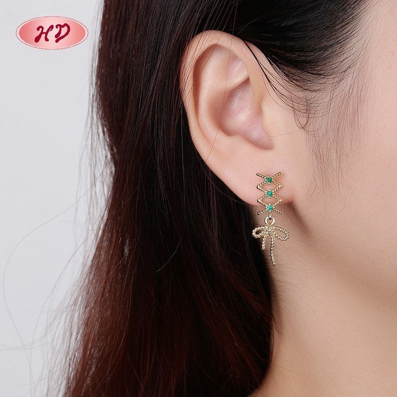 Model wearing the green cubic zirconia drop earrings