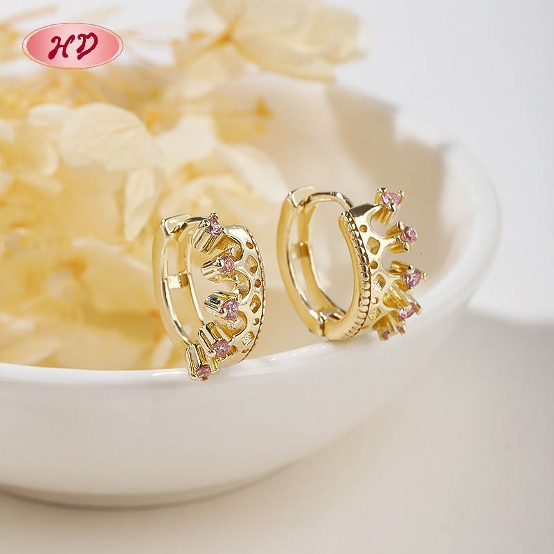 Pink CZ crown huggie earrings styled for bridal and spring display