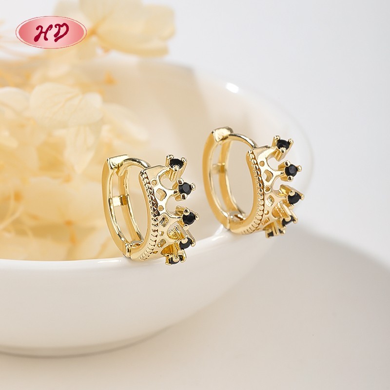 Black CZ crown huggie earrings styled for evening and formal wear display