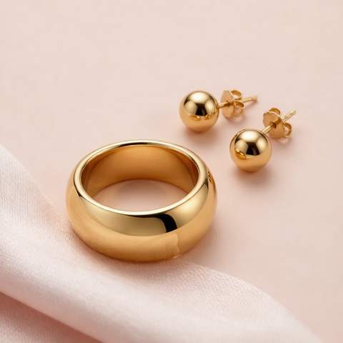 Close-up of 18K gold plated ring and stud earrings with a mirror-polished surface