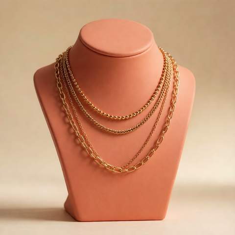 18K gold plated layered necklace draped on a coral jewelry bust