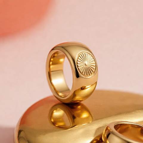 18K gold plated ring on a polished brass ingot showing the real gold surface layer