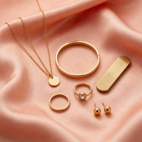 Flat lay of 18K gold plated jewelry with a brass sample bar