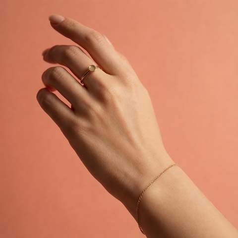 Woman wearing 18K gold plated ring and bracelet on skin
