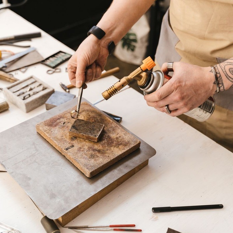 Jeweler crafting a ring at the workbench in our Shanwei (Haifeng) factory