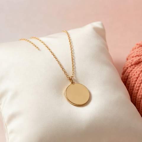 Gold plated necklace draped on a silk surface