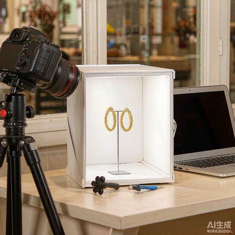 A compact jewelry photography studio with a camera on a tripod aimed at gold-plated earrings on a lightbox