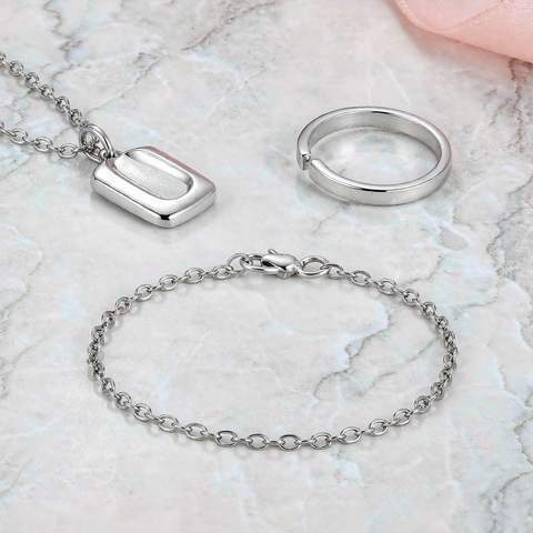 Stainless steel jewelry flat lay with silver tones
