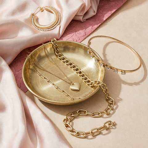 Styled flat-lay of gold plated jewelry