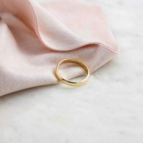 Wiping a gold-plated ring with a soft polishing cloth