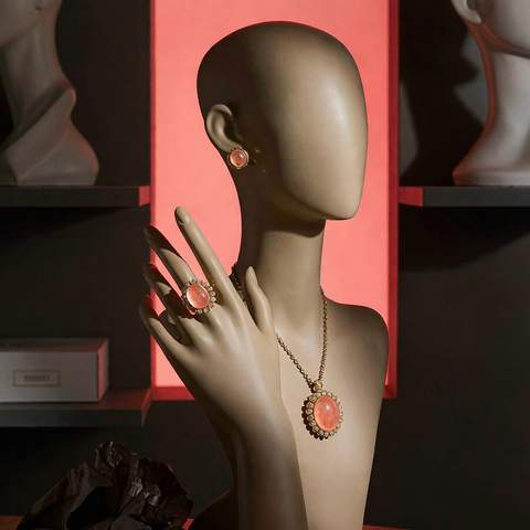 Gold plated fashion jewelry set displayed on a jewelry bust