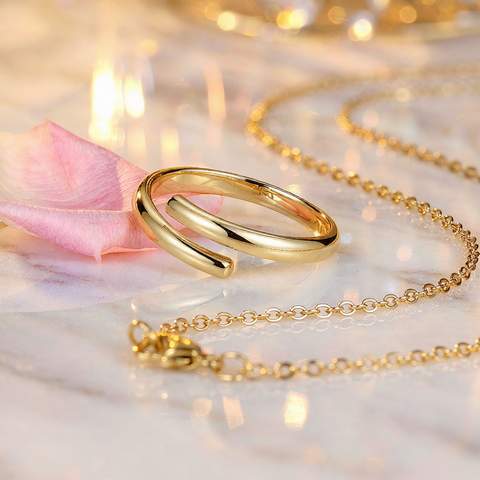 Gold-plated ring and necklace on marble