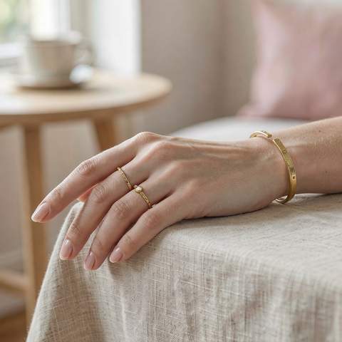 Gold-plated bangle and ring on a model hand
