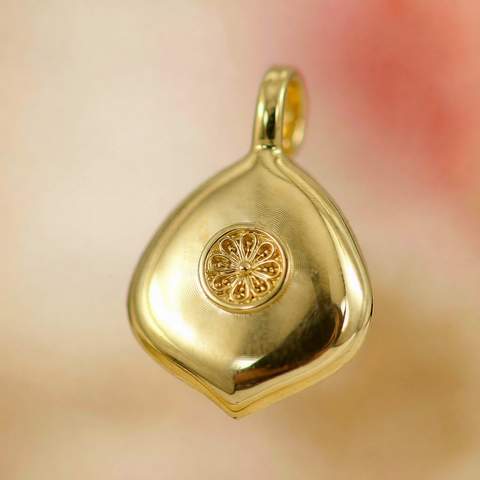 Macro detail of a gold plated pendant finish