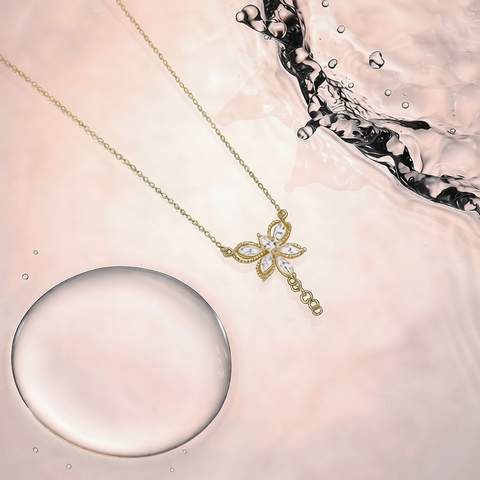 Gold plated necklace with CZ stones beside a dynamic water splash