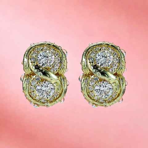 Pair of gold plated earrings with CZ stones on a soft pink background