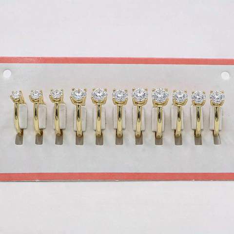 Row of gold plated CZ earrings on a display card showing new stock condition