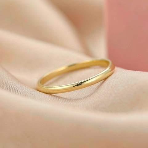 Gold plated ring resting on soft fabric, illustrating surface contact