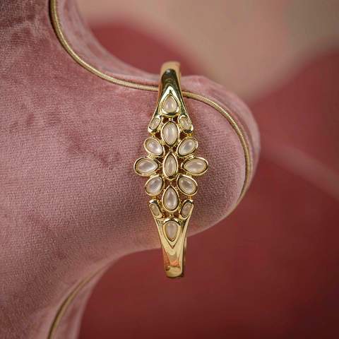 Gold plated bracelet displayed on a pink velvet bust