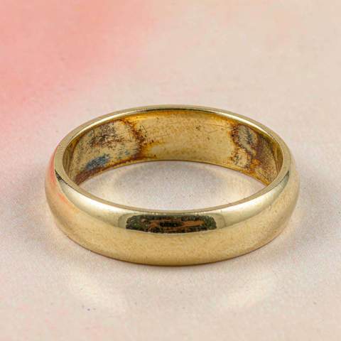 Gold plated ring showing dark discoloration where the plating has worn thin on the inner band