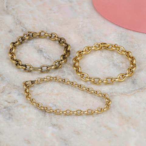 Gold plated chains compared side by side, one darkened by discoloration next to bright clean pieces