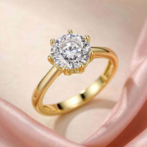 Gold plated solitaire ring with a round cubic zirconia held by six prongs