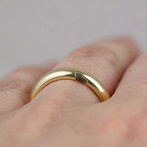 Close-up of a gold plated ring showing a small darkened patch on the band