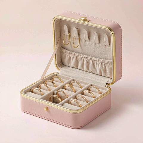 Gold plated rings and earrings stored separately in a lined jewelry case