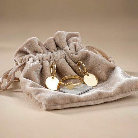 Gold plated jewelry resting in a soft anti-tarnish pouch