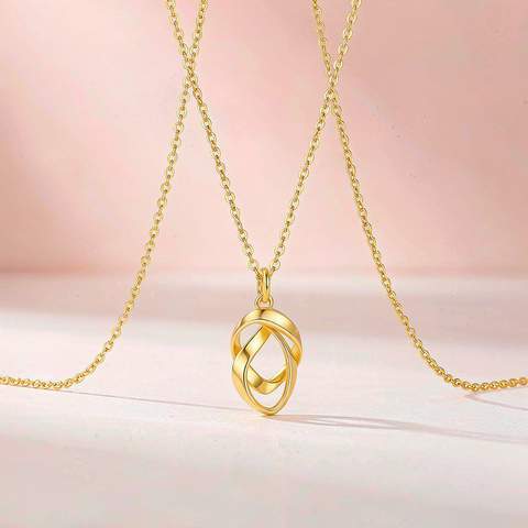 18K gold plated pendant necklace displayed with blush pink studio styling