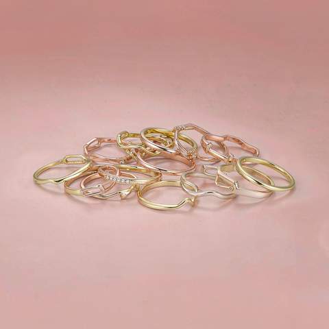 18K gold plated rings arranged on a soft blush surface
