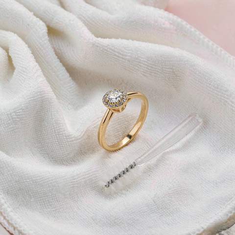 Cubic zirconia ring being cleaned gently on a microfiber cloth