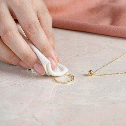 Wiping an 18K gold plated ring with a soft cloth
