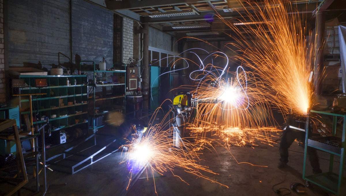 Metal fabrication workshop supporting custom heavy duty table base production