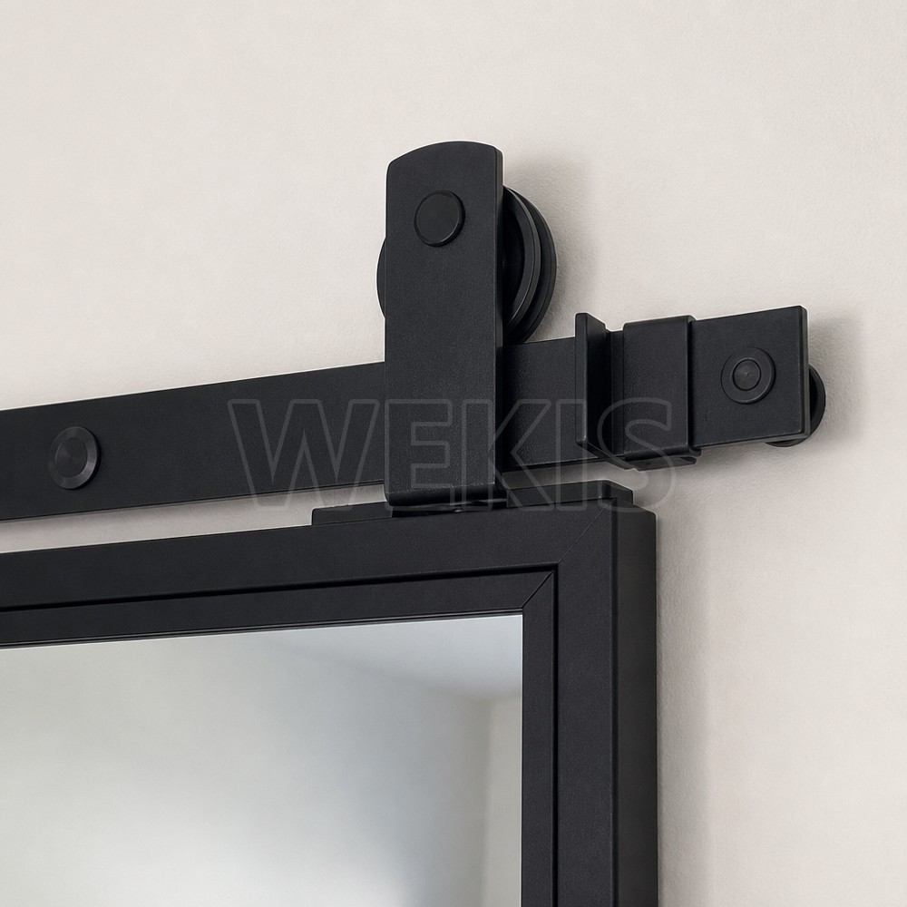 Black barn door hanger and roller wheel running on the flat top rail