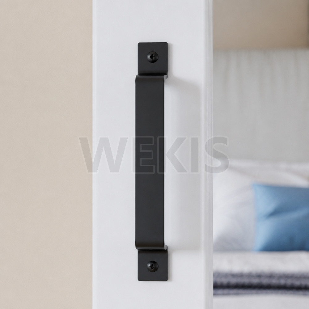 Square profile black pull handle mounted on the white door frame