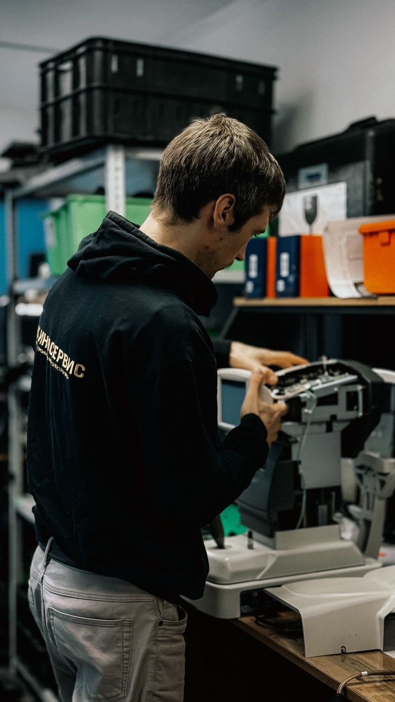 Technician working on printer in workshop