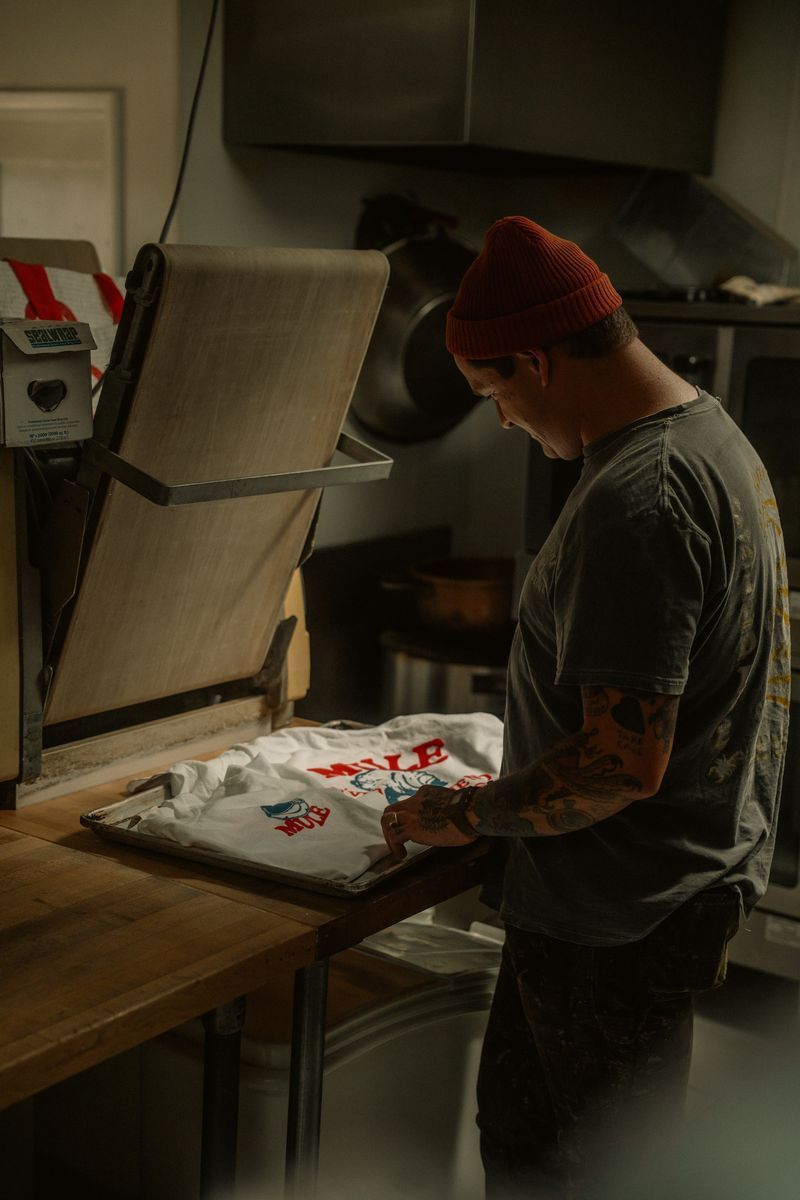 Heat press transferring DTF print onto garment