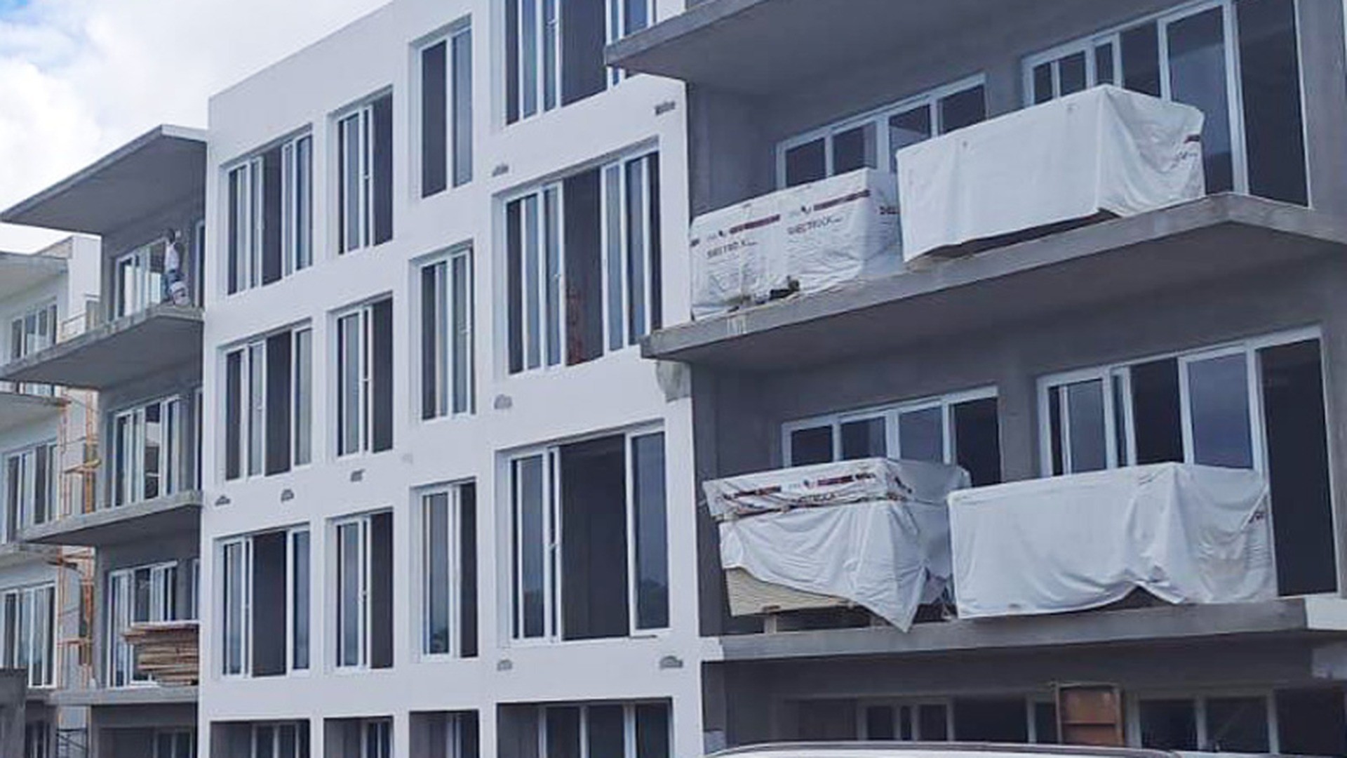 Protective film still fitted to the window frames of a new apartment building before handover