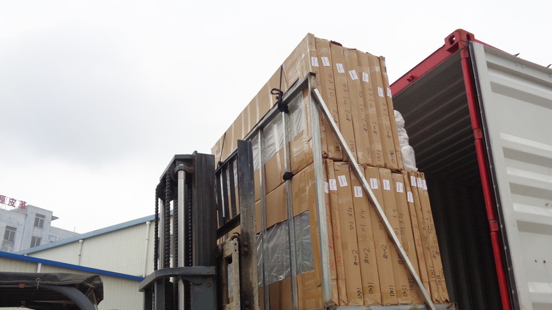 Loading day: crates lifted into the container one at a time and checked against the order list