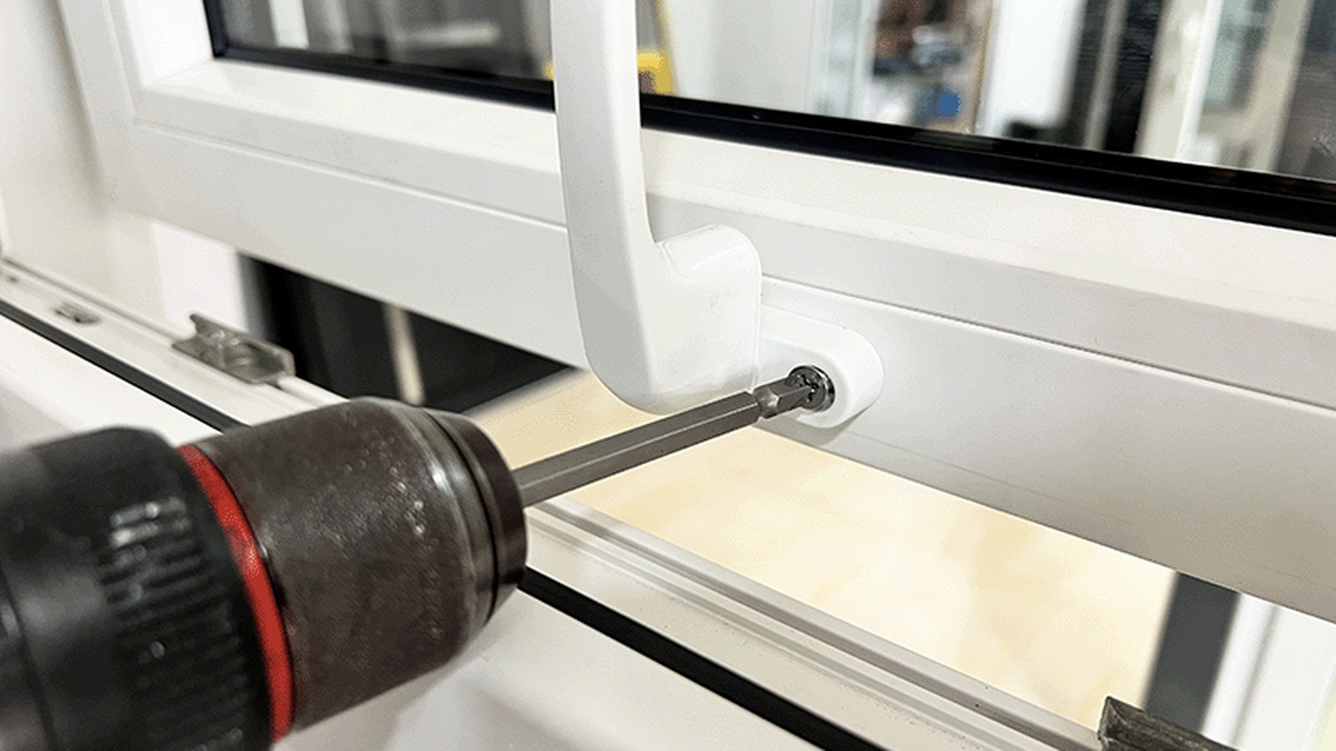 A handle fixing being tightened with a screwdriver as part of routine hardware care.