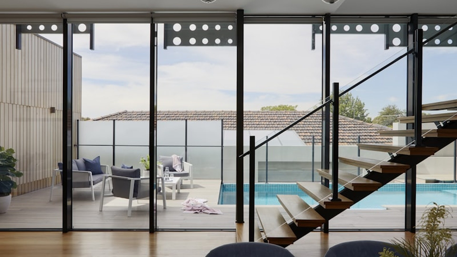 Full-height sliding glass doors in a finished home, opening directly onto a deck: the configuration where sash locks and laminated glazing do most of the work.