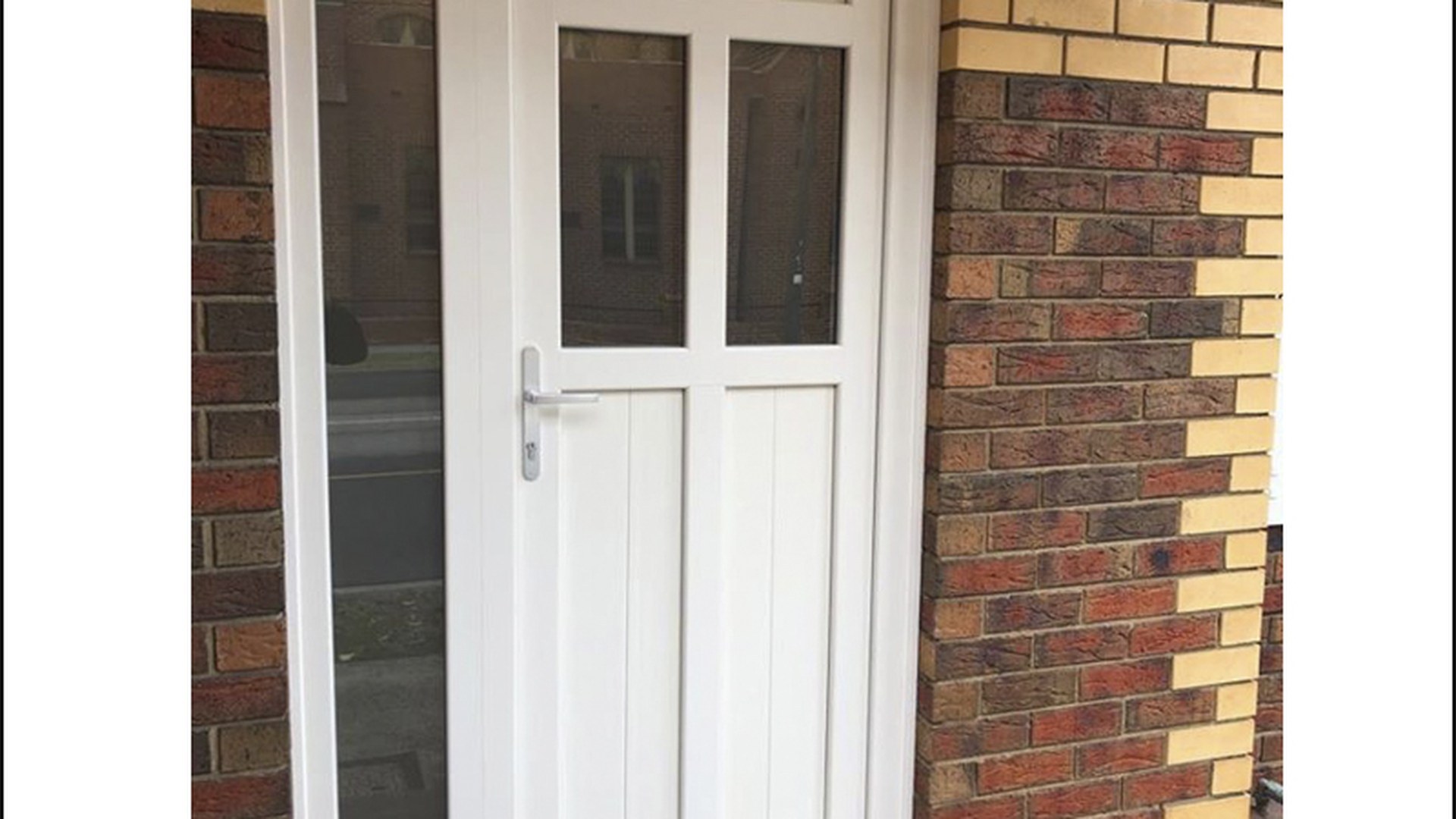 A white uPVC entrance door in a completed brick opening: the configuration most importers build their first catalogue order around.